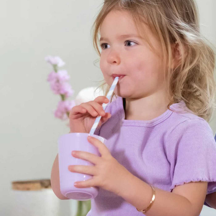 Child drinking cup of Captain Calm powder for relaxation